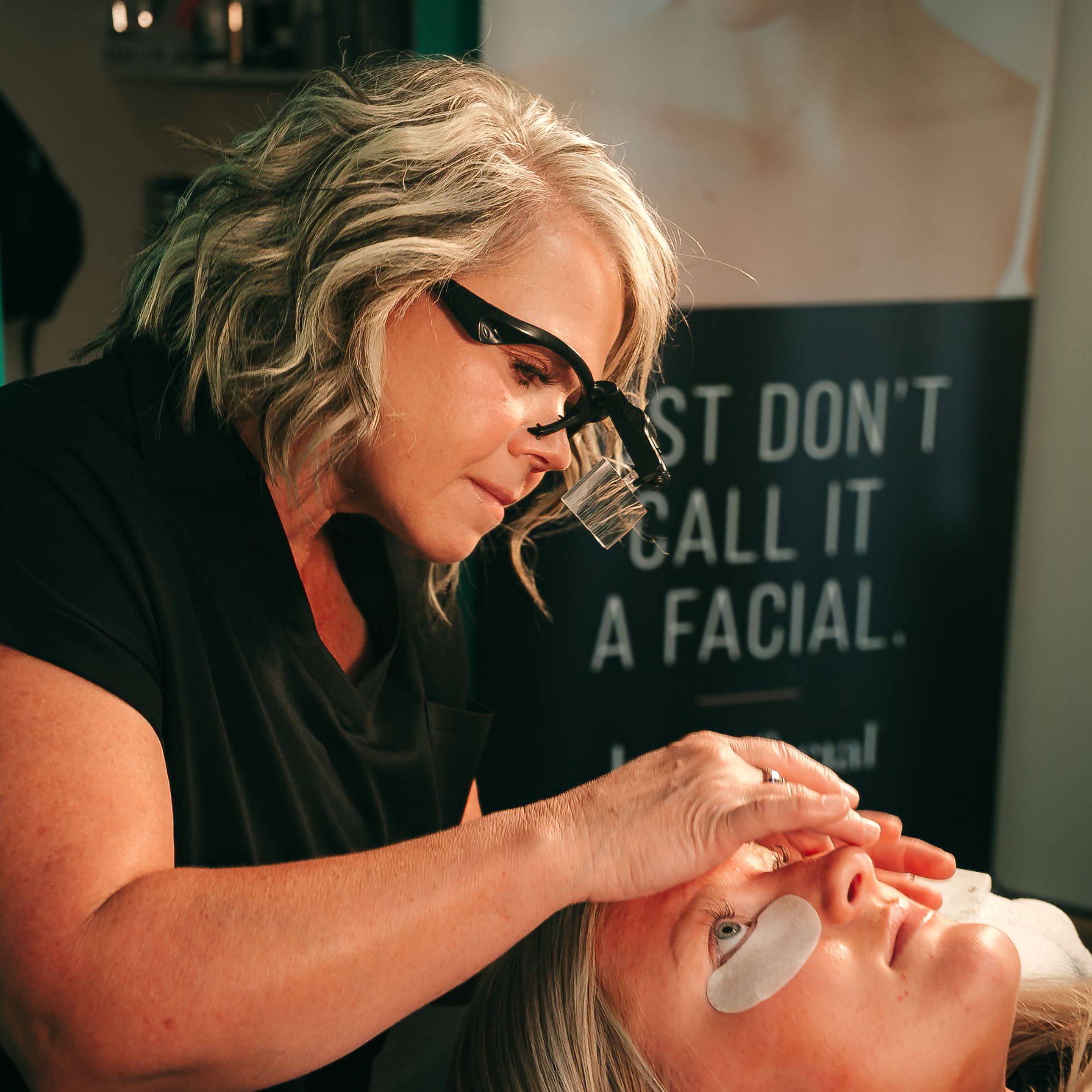 Woman receiving facial oil treatment