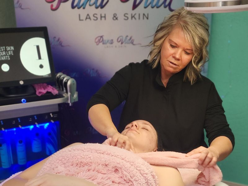 Woman receiving a HydraFacial treatment, glowing skin