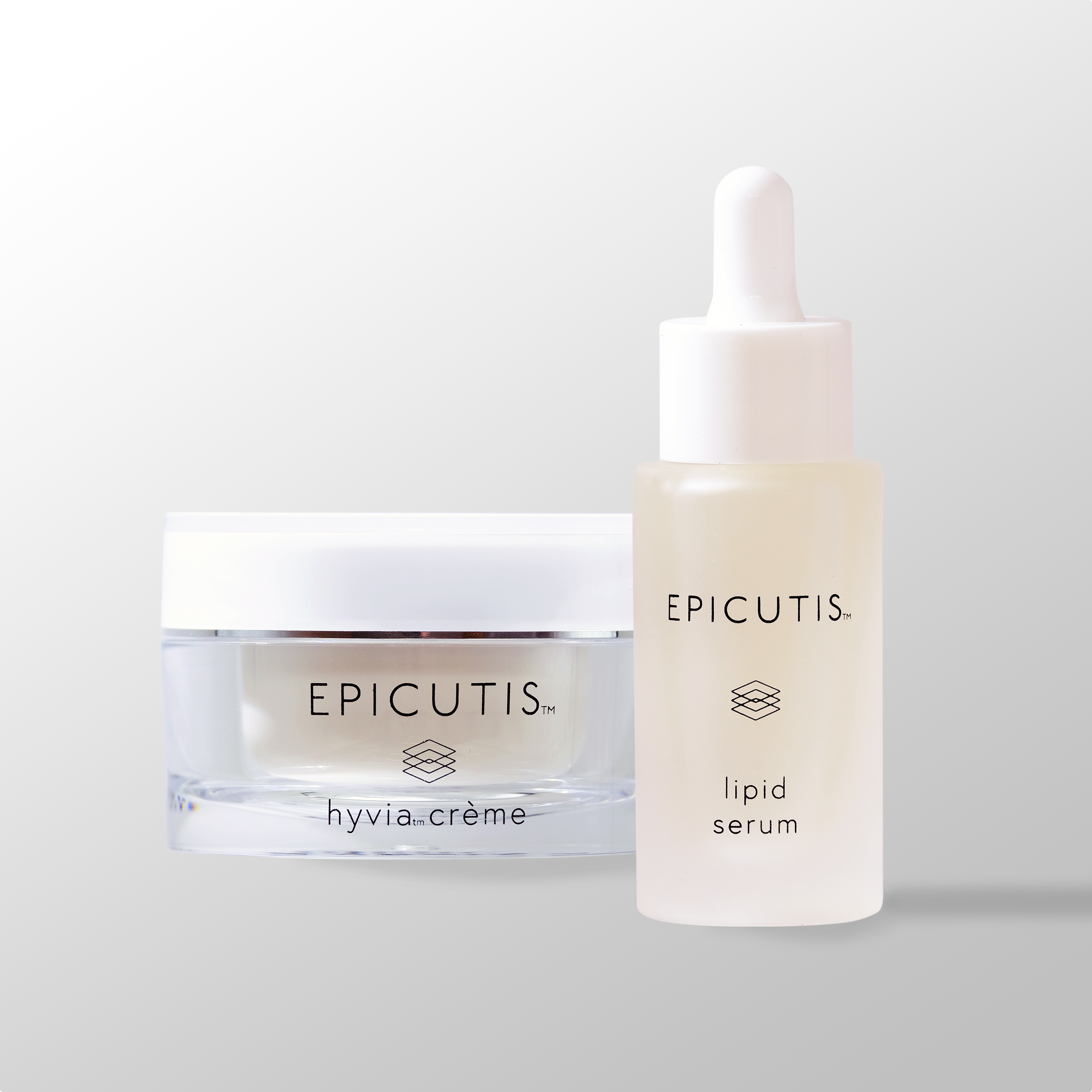Woman applying luxury skincare serum with jade roller